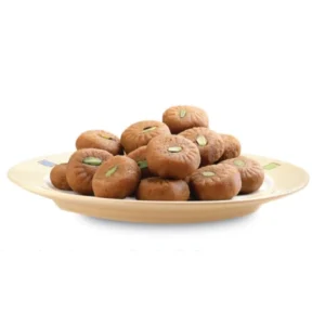 Plate of round chocolate sweets with pistachio pieces.