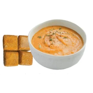 Creamy tomato soup served with toasted bread squares.