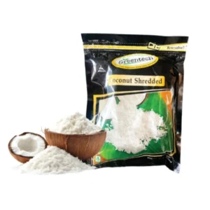 Packaged desiccated coconut with a cracked coconut and shredded coconut beside it.