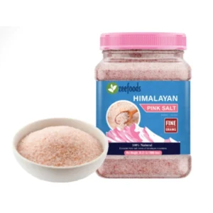 Jar of Himalayan pink salt with a bowl of salt beside it.