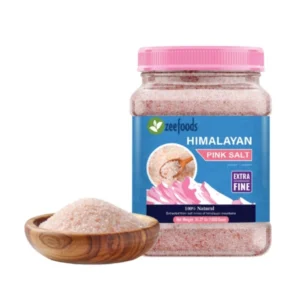 Jar of Himalayan pink salt beside a wooden bowl filled with salt.