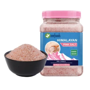 Jar of pink Himalayan rock salt with a black bowl of salt beside it.